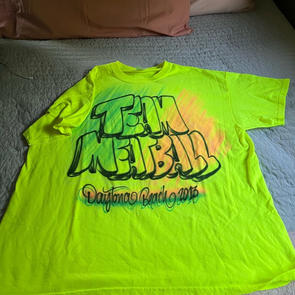 Bright yellow t-shirt. Graphic on the front nothing on the back.